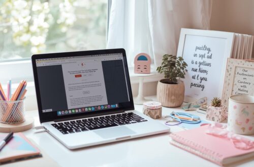 Minimalist home office setup with a pink keyboard and a laptop, representing professional freelance writing and editing